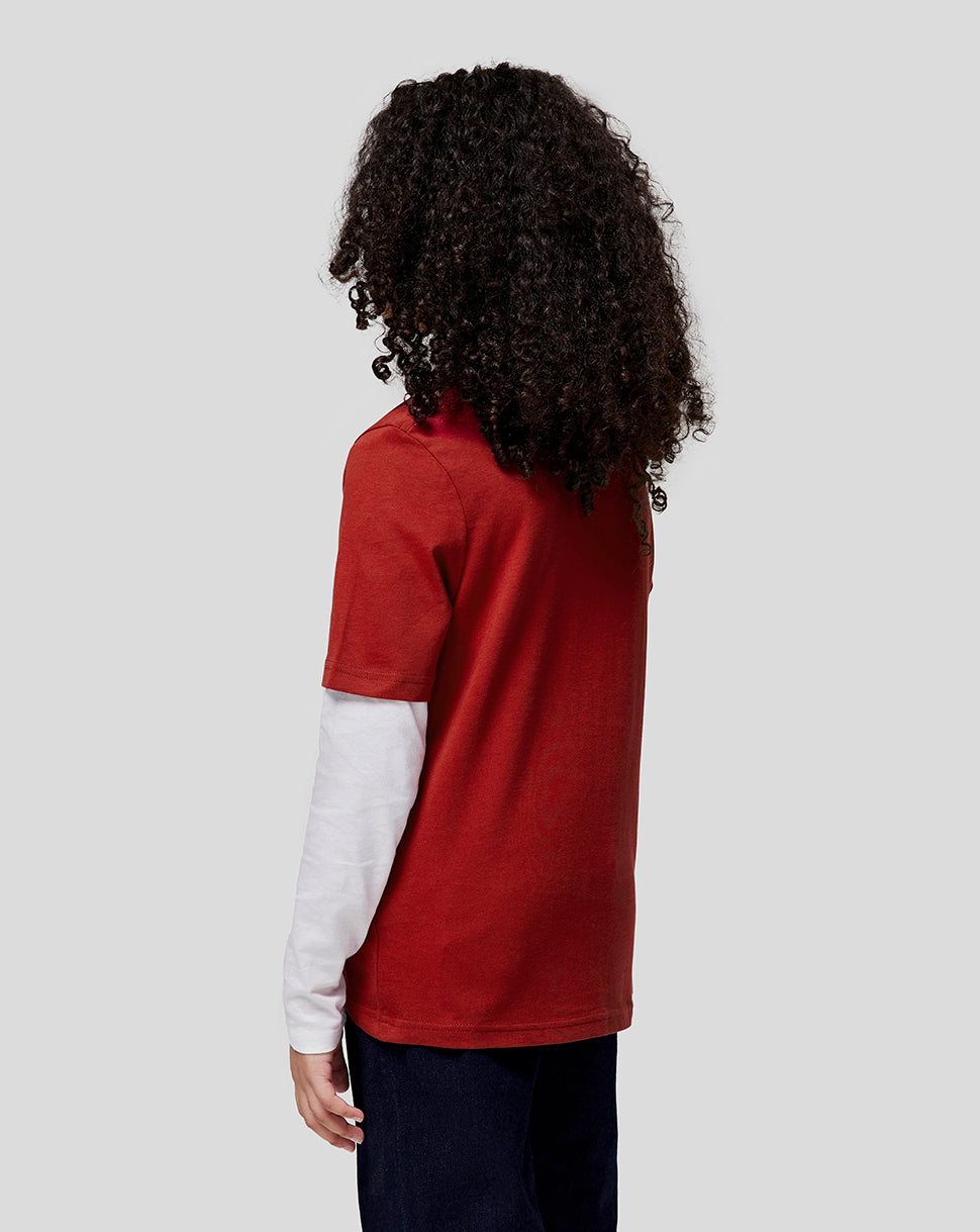 Back view of a child wearing a red Oracle Red Bull Racing juniors tee over a white long sleeve top