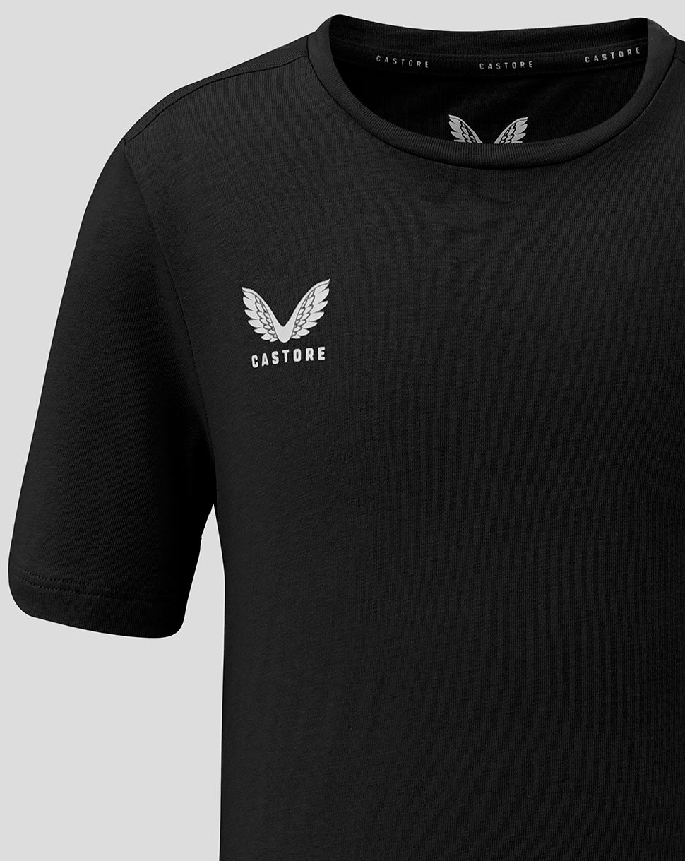 Close up of a black Junior Cotton Leisure Tee with white Castore wing logo on the left chest