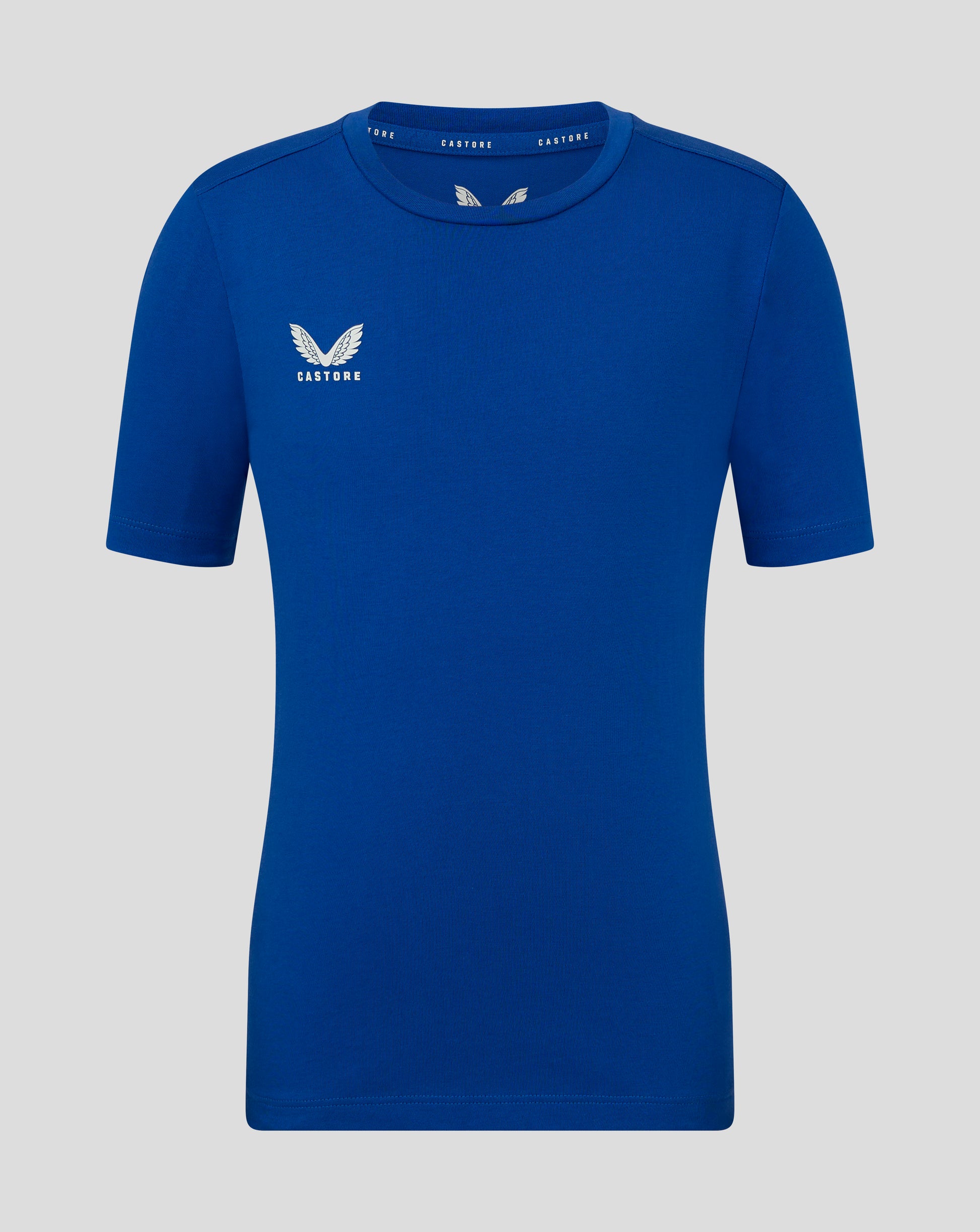 Front view of blue Junior Cotton Leisure Tee with Castore logo on the left chest and branding along the inside neck.