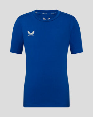 Front view of blue Junior Cotton Leisure Tee with Castore logo on the left chest and branding along the inside neck.
