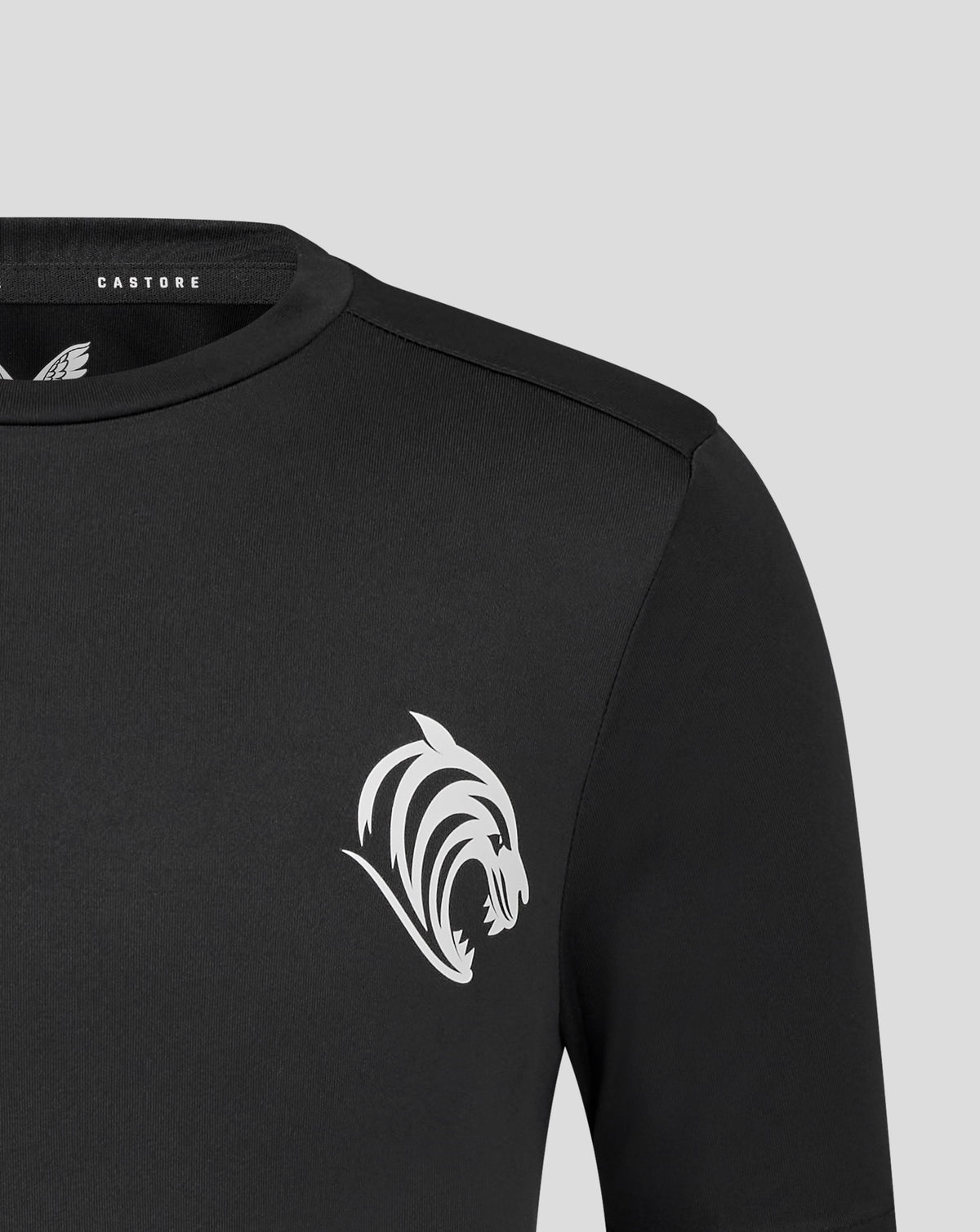 Close up of black Leicester Tigers training T shirt with white tiger emblem on the chest and Castore label at the neckline