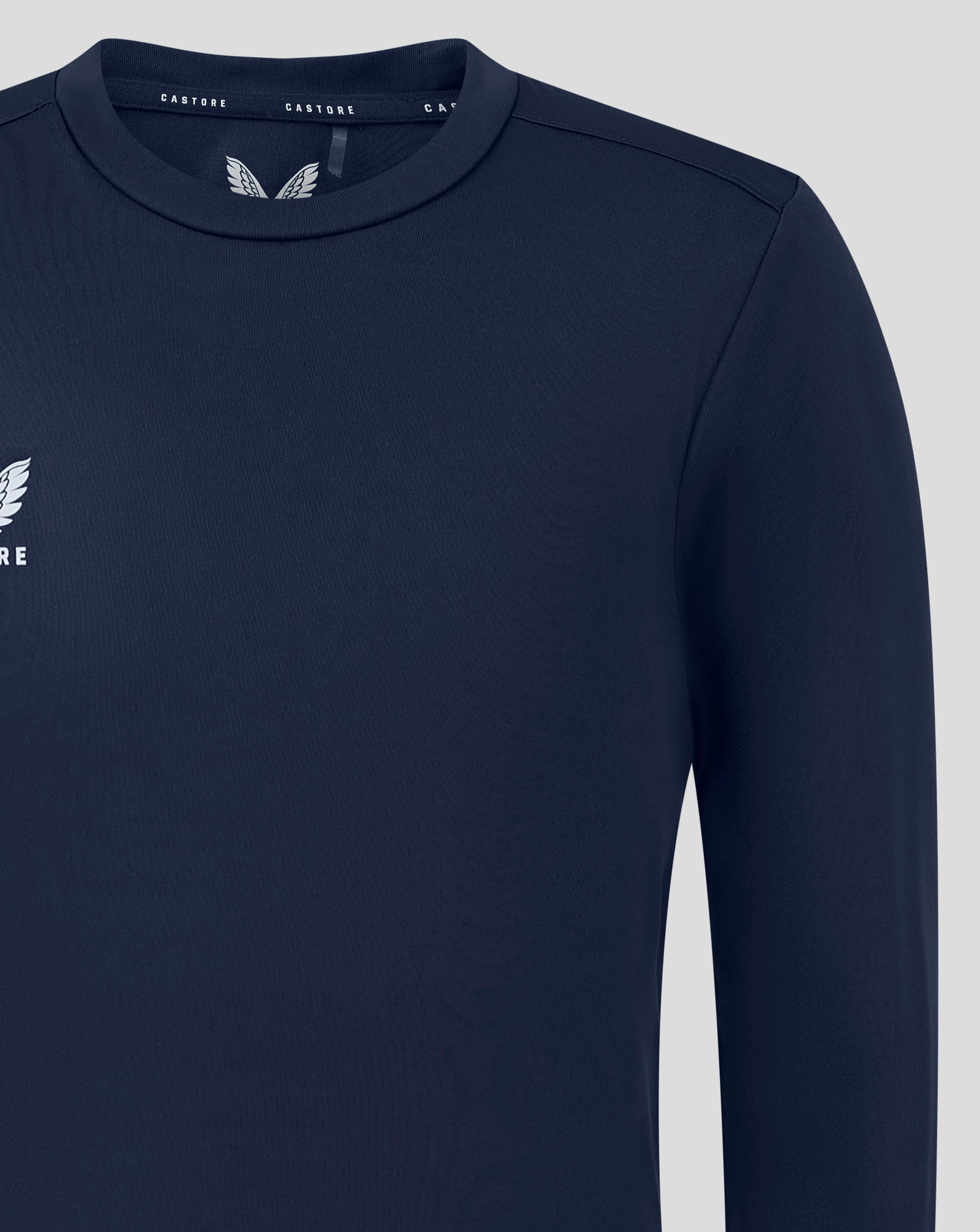 Close up of navy junior long sleeve tee neckline showing Castore branding on the inside collar