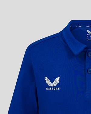 Blue polo shirt with white wing logo and CASTORE wordmark on chest.