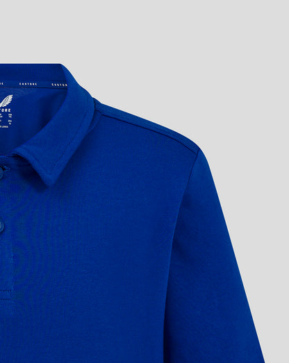 Blue polo shirt close up at the collar showing the inner label and wing logo.