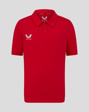 Bright red Junior Cotton Leisure Polo with self fabric collar two button placket and white Castore logo on left chest