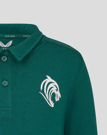 Close-up of the chest area showing the white tiger head crest on the green polo fabric
