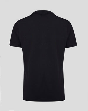 Back view of black Junior Cotton Leisure Polo showing self fabric collar forward shoulder seam and heat sealed Castore logo at the neck