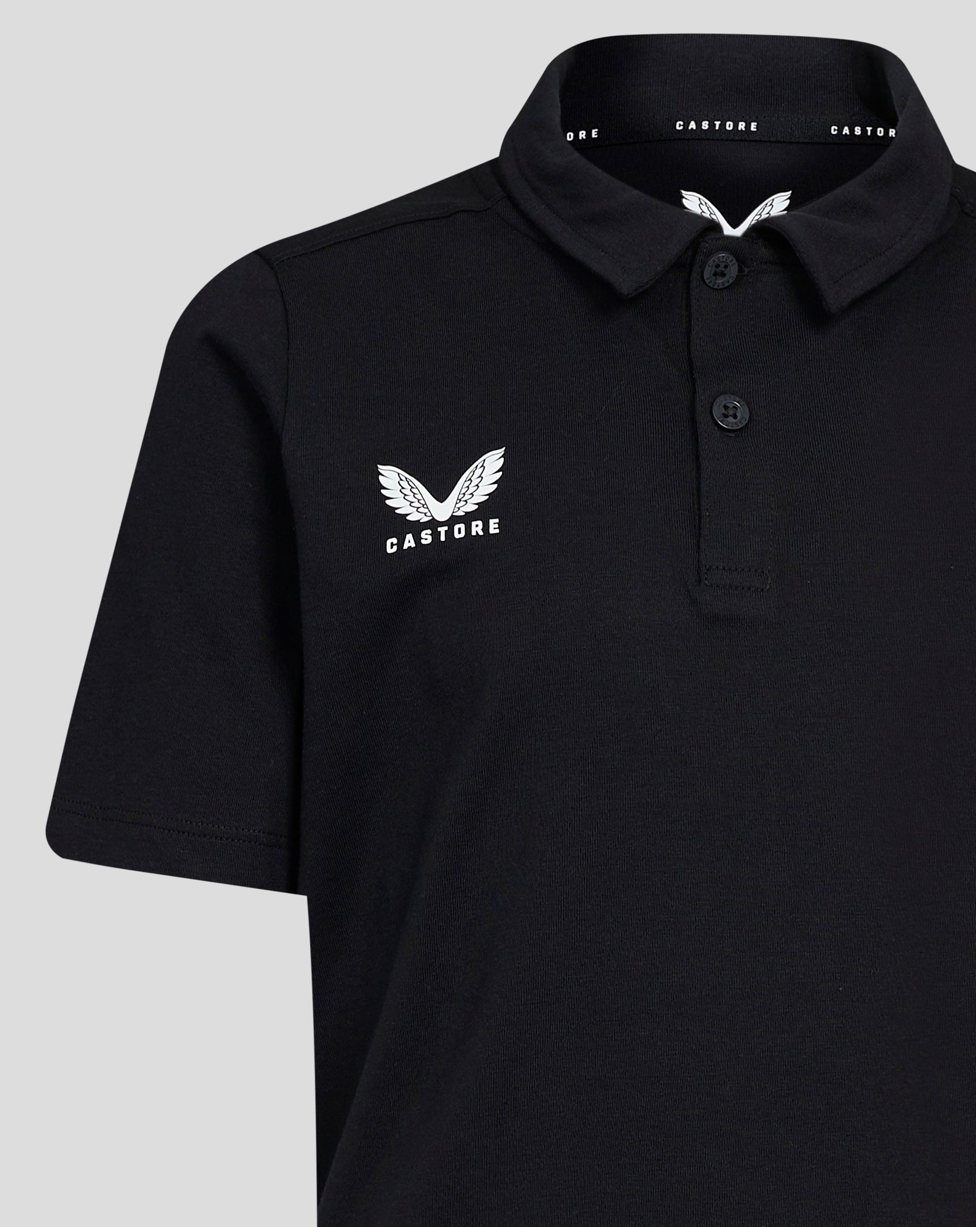 Front view of black Junior Cotton Leisure Polo with self fabric collar three button placket and Castore wing logo on left chest