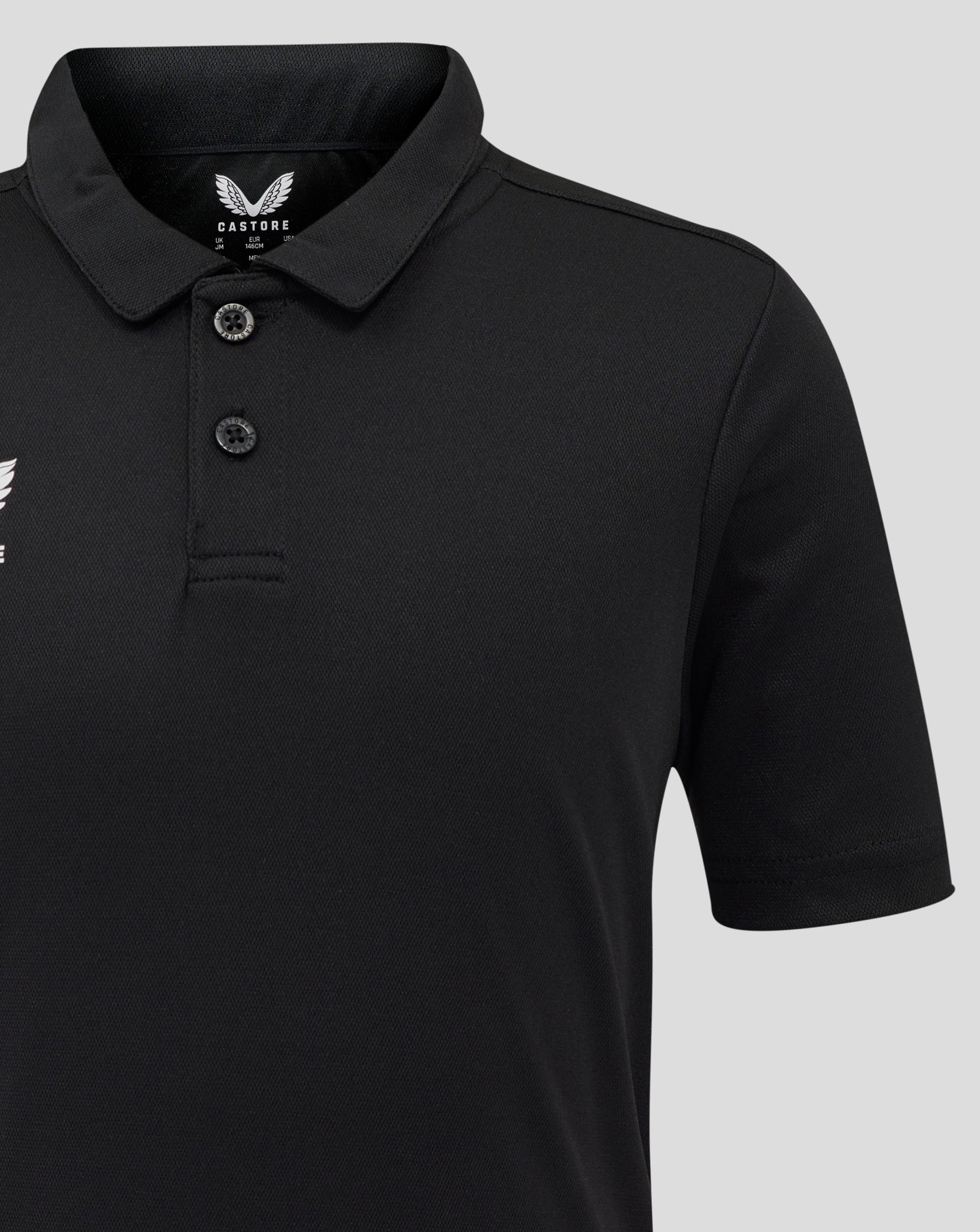 Close-up of the polo collar and placket in black with Castore branding at the collar