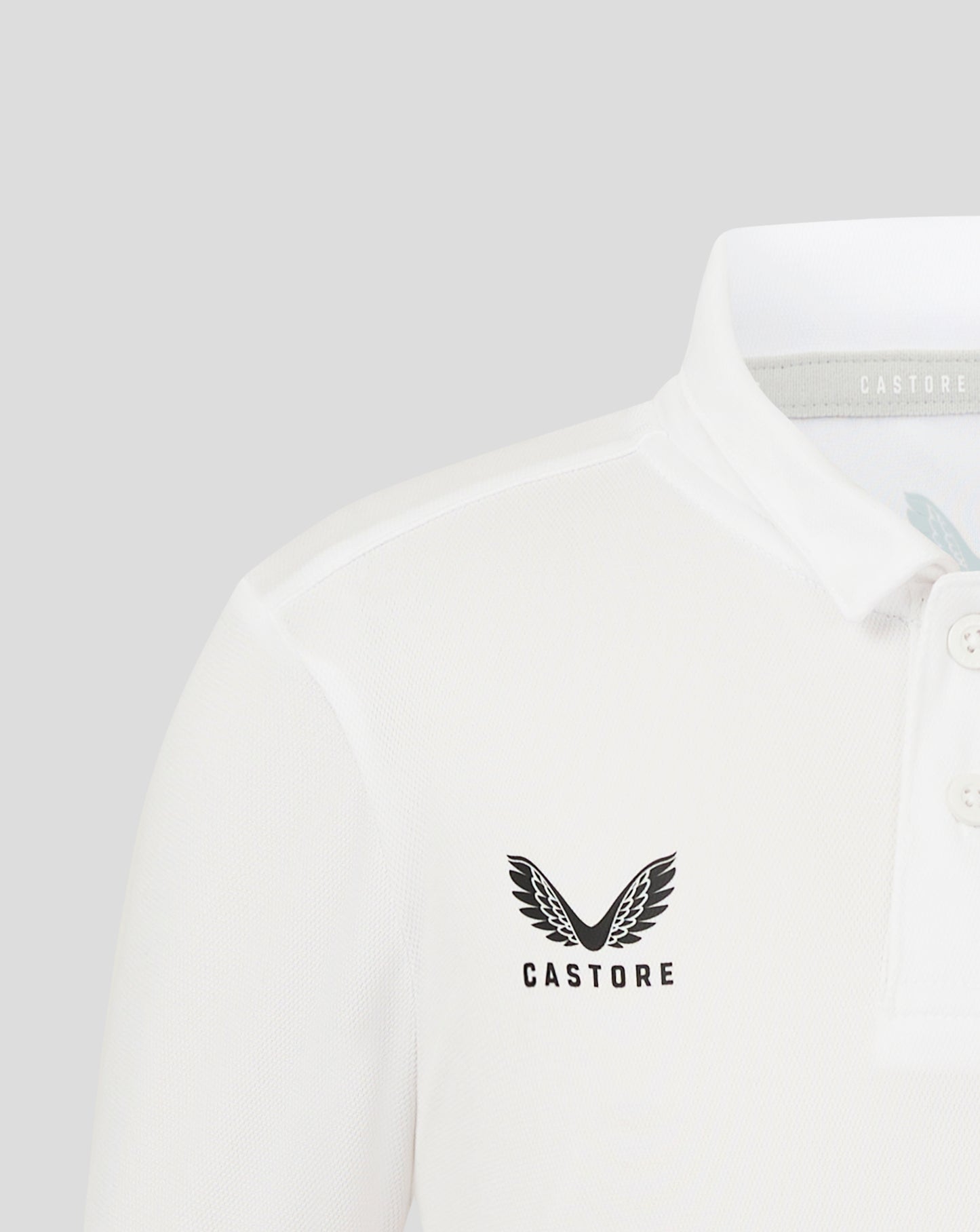 Junior Performance Polo in Brilliant White with self fabric collar three button placket and heat sealed Castore logo