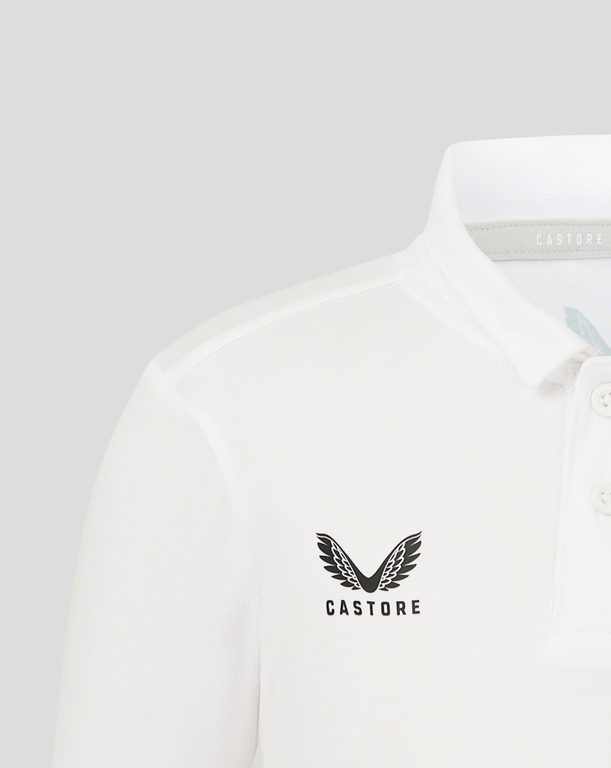 Junior Performance Polo in Brilliant White with self fabric collar three button placket and heat sealed Castore logo