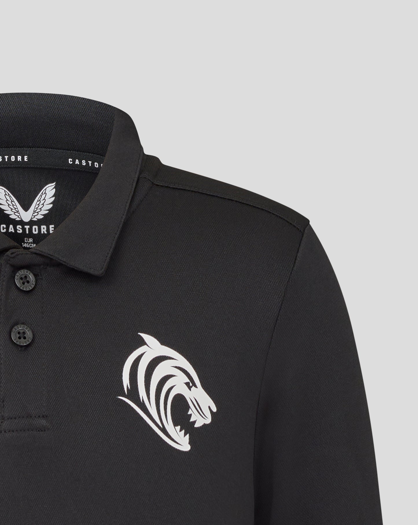 Front view of black Leicester Tigers junior training polo with prominent white crest graphic