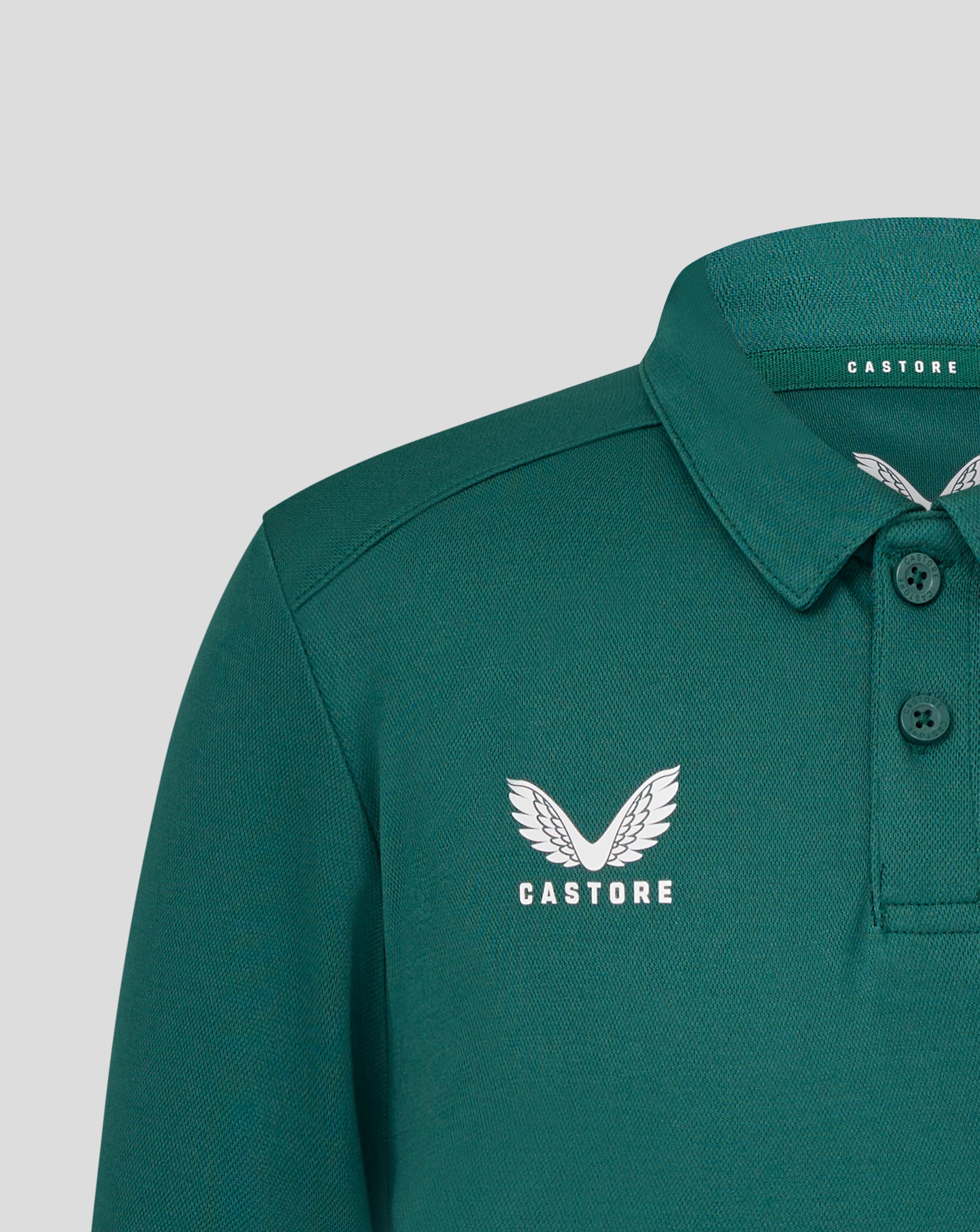 Teal green Leicester Tigers training polo close up showing white winged crest on chest and Castore branding