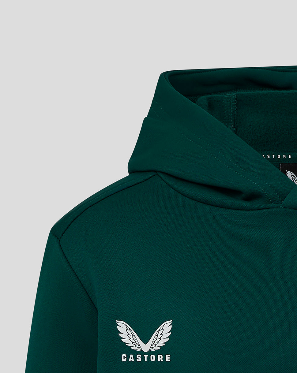 Close up of the dark green hoodie at the shoulder with hood and Castore logo on the chest