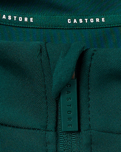 Close up of the teal 1/4 zip collar showing zipper and branding tag with Castore logo