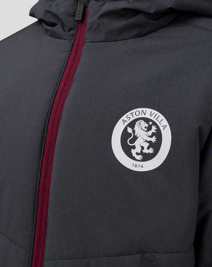 Close up of dark Junior Aston Villa Coaches Long Bench Jacket with a white circular crest and burgundy zipper.