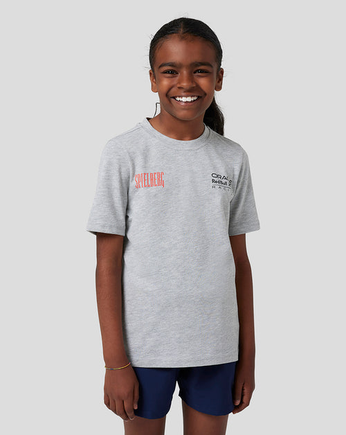 Boy in grey marl Red Bull Racing Spielberg T Shirt with Spielberg graphic and Oracle Red Bull Racing logo on the chest.