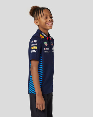 Junior wearing navy Night Sky Oracle Red Bull Racing Teamline short sleeve polo with jacquard knit and side mesh panels.
