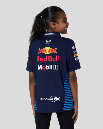 Back view of a child wearing a navy polo with blue striped side panels and Red Bull branding on the back