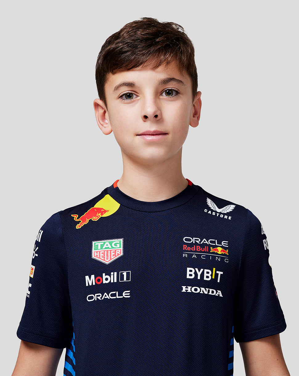Boy wearing a night sky navy Oracle Red Bull Racing Set Up Tee, front view showing breathable fabric and logos.