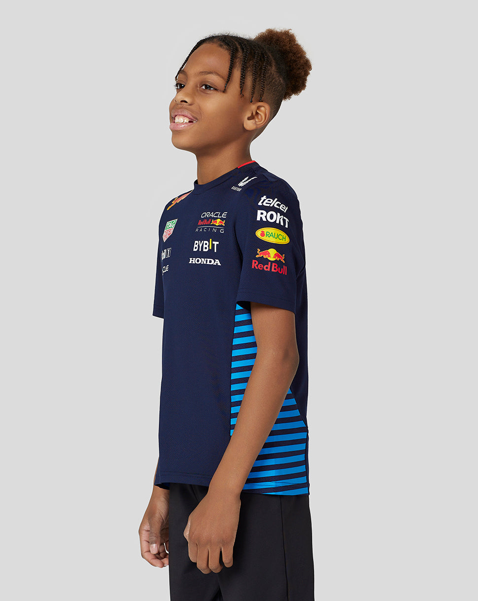 Youth model wearing navy Night Sky Oracle Red Bull Racing Set Up Tee with sponsor logos and side mesh panels.