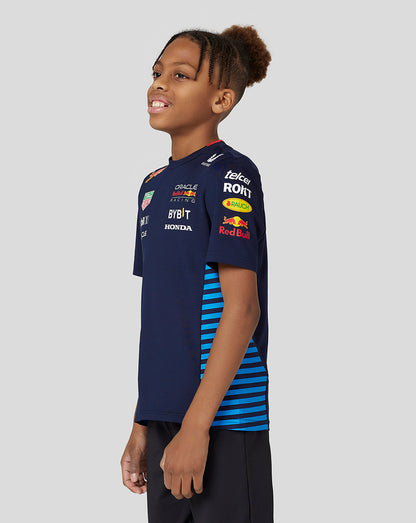 Youth model wearing navy Night Sky Oracle Red Bull Racing Set Up Tee with sponsor logos and side mesh panels.