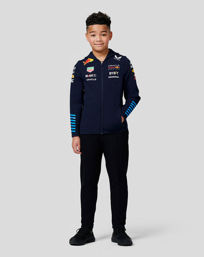 Young model wearing navy Night Sky Oracle Red Bull Racing Teamline full zip hoodie with sponsor logos and blue striped sleeves.