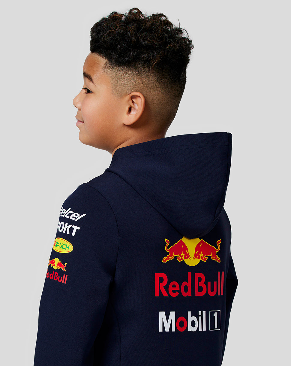 Back view of a junior navy hoodie with a large Red Bull logo on the back and sponsor logos on the sleeves.