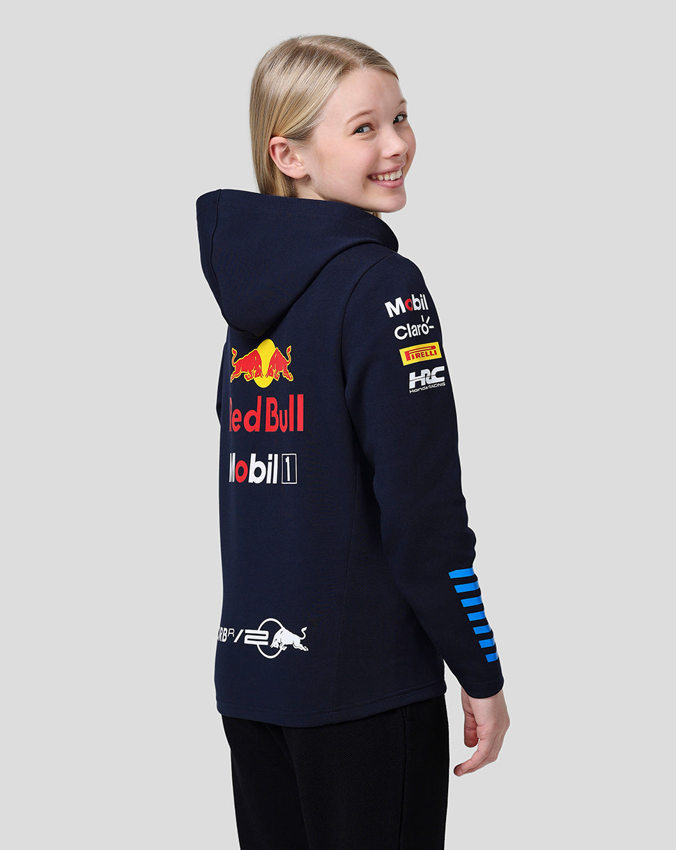Side view of a young wearer in a navy Red Bull Racing Teamline hoodie showing blue stripe details on the sleeve