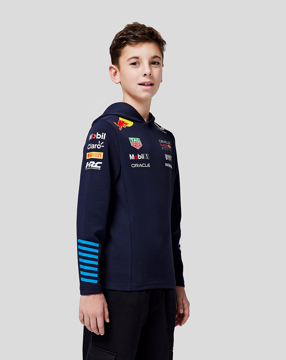Boy modeling a navy Oracle Red Bull Racing Teamline hoodie with sponsor logos on the chest and sleeve against a light gray background