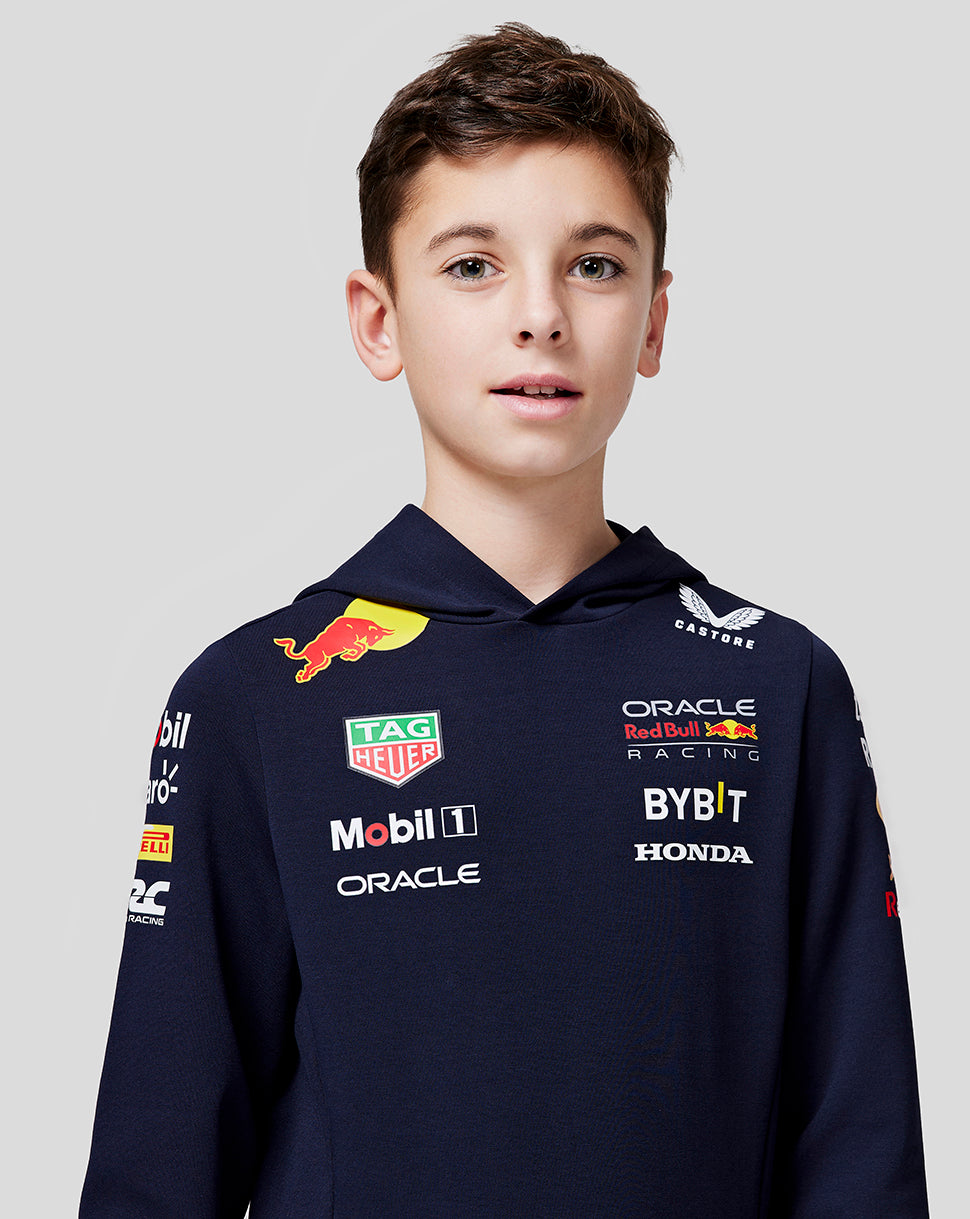 Front view of a boy wearing a navy Teamline hoodie with multiple sponsor logos on the chest and sleeves