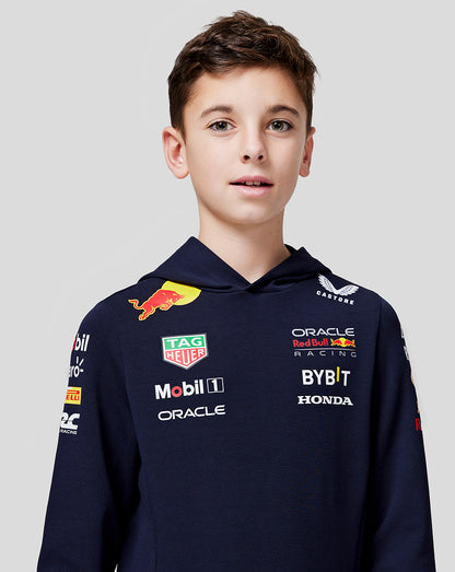 Front view of a boy wearing a navy Teamline hoodie with multiple sponsor logos on the chest and sleeves