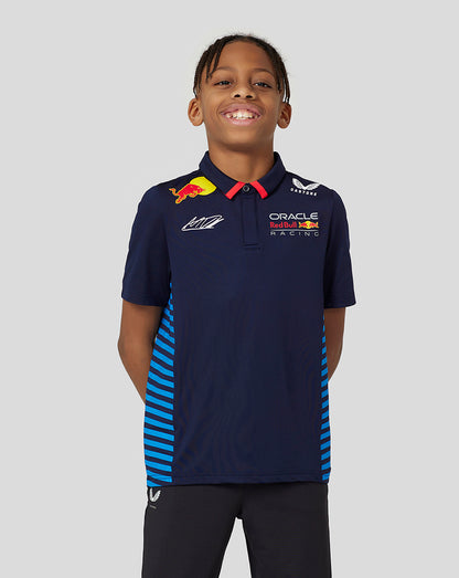 Young boy in navy Oracle Red Bull Racing Verstappen junior polo with team logos and red collar.
