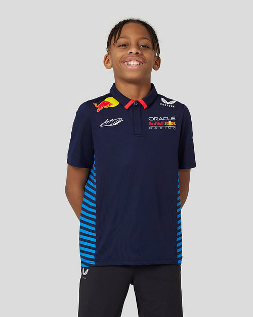 Young boy in navy Oracle Red Bull Racing Verstappen junior polo with team logos and red collar.