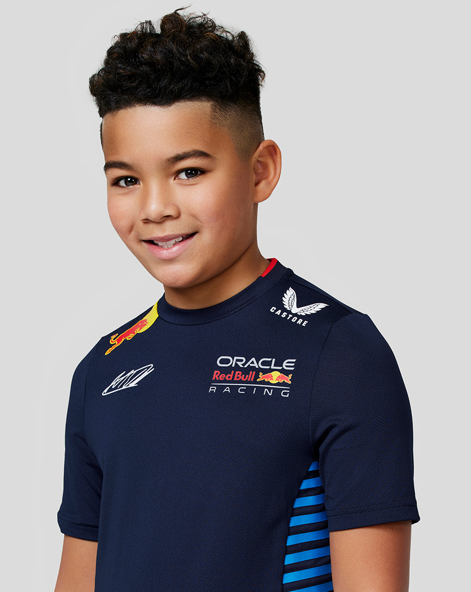 Close up of a kid in the Night Sky Teamline shirt showing Oracle Red Bull Racing and Red Bull logos on the chest