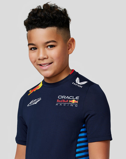 Close up of a kid in the Night Sky Teamline shirt showing Oracle Red Bull Racing and Red Bull logos on the chest