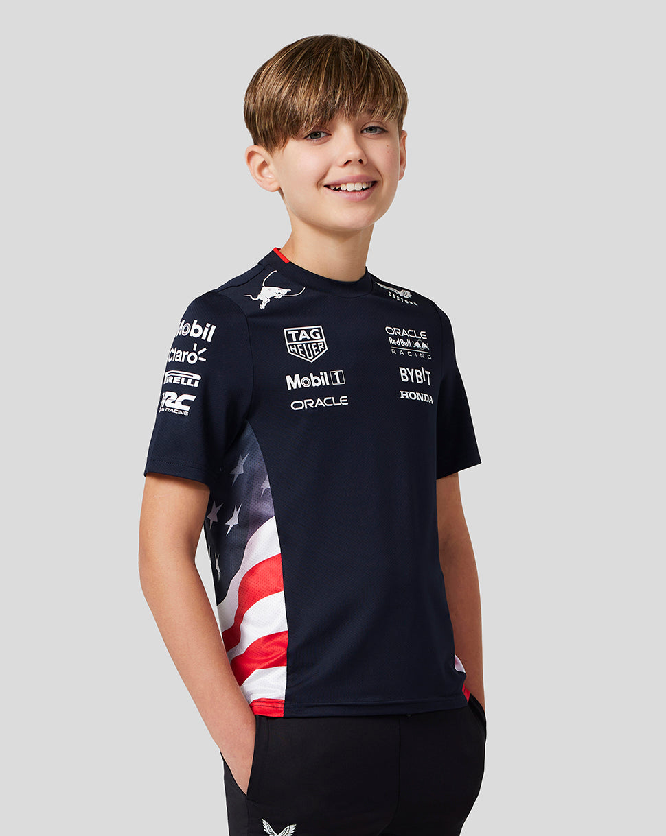 Boy in navy Night Sky America Race Team T Shirt with sponsor logos and side flag panel