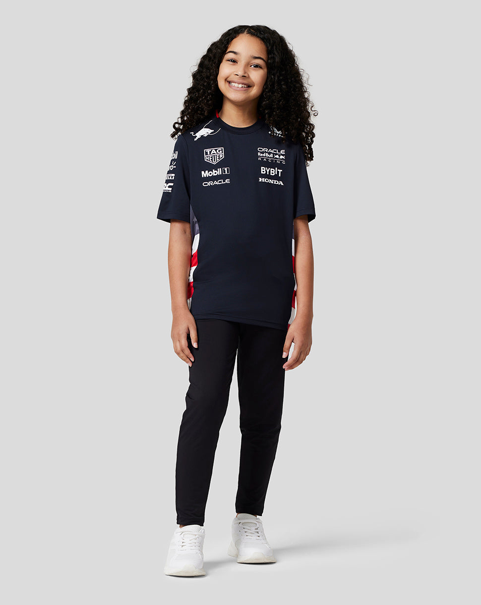 Young girl model wearing navy Oracle Red Bull Racing Junior Teamline America Race Team T Shirt with sponsor logos on chest and sleeves.