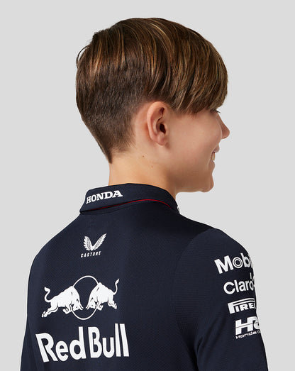 Back view of a boy in a Night Sky navy polo with large Red Bull Racing back logo and sponsors.