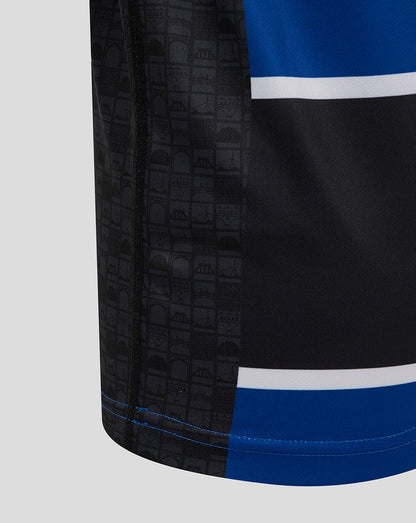 Close-up of Bath Rugby Junior Home Shirt side panel with black patterned block blue stripe and blue hem.
