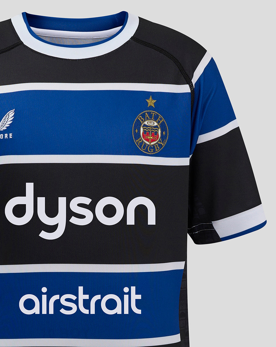 Close up front of Bath Rugby Junior Home Shirt showing the Bath crest on the left chest and Dyson sponsor across the blue stripe.