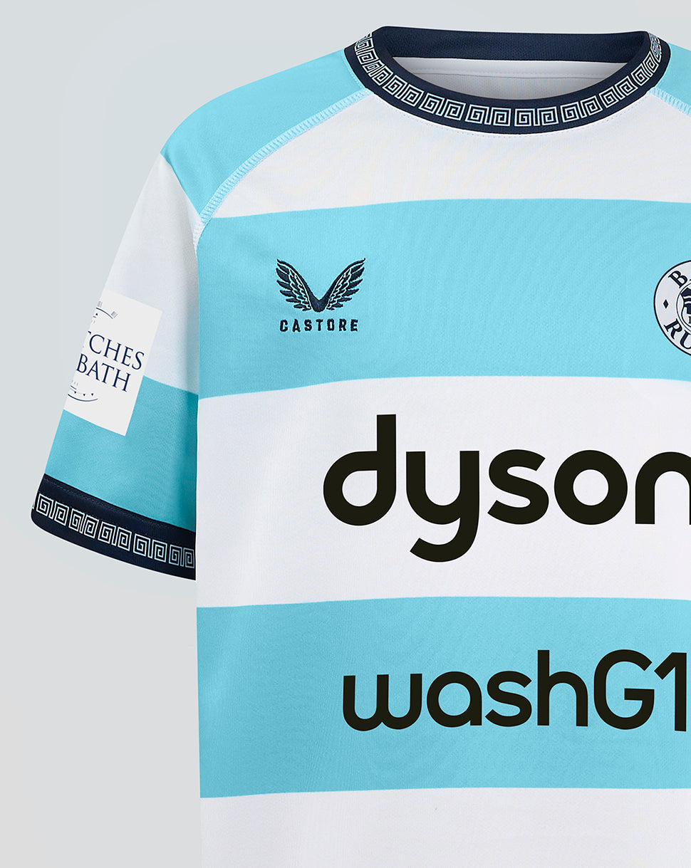 Close-up of Bath Rugby Junior Euro Shirt 24/25 chest area with turquoise and white stripes, crew neck Greek key trim, Castore logo left chest and Bath Rugby crest right