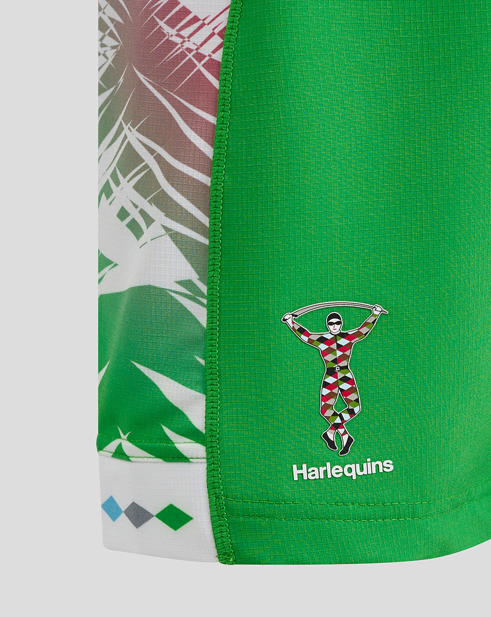 Detail shot of green Harlequins junior away shorts showing the crest and side panel pattern.