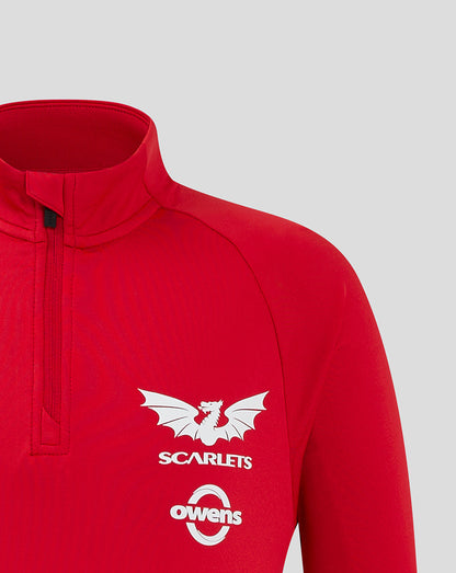Close-up of red midlayer chest showing the white Scarlets crest and Owens logo.