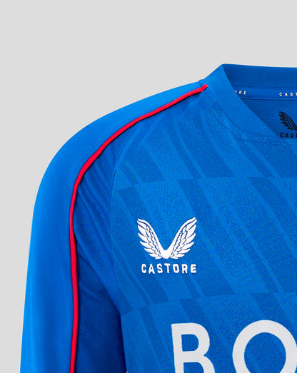 Close up of blue Rangers junior home shirt showing Castore logo on chest and partial BOXT lettering across the front