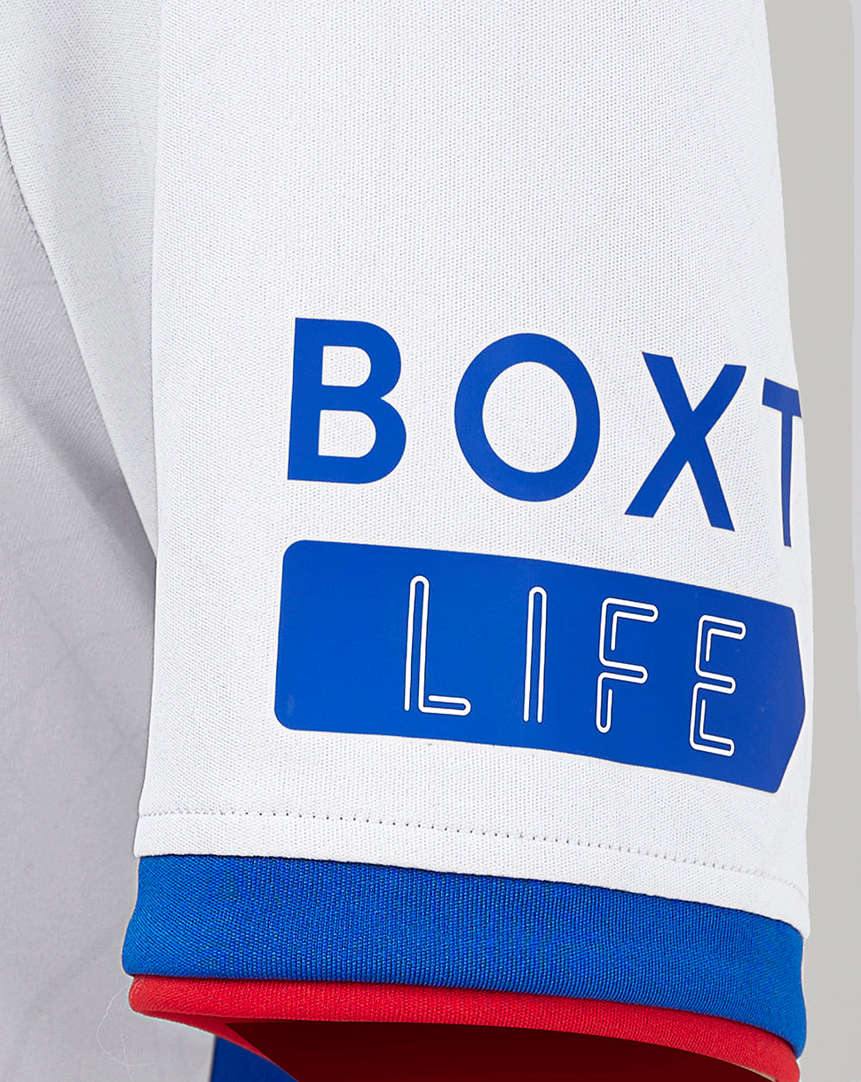Rangers Junior Away Shirt sleeve close up showing BOX LIFE print in blue on white fabric with blue and red cuff trim