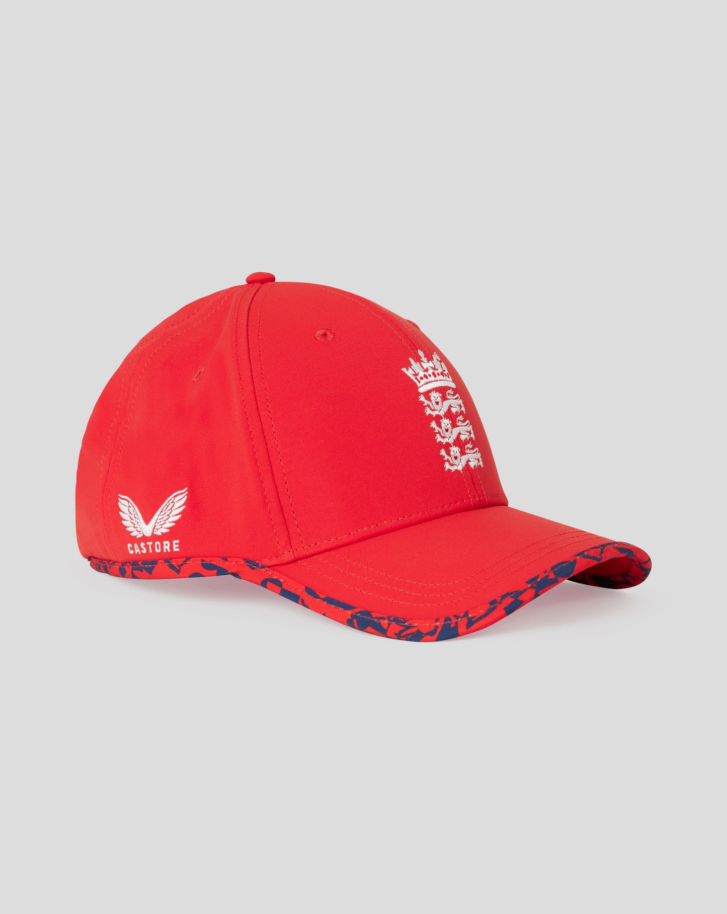 Front view of fiery red England cricket junior T20 cap with white crest on the front and a blue patterned brim.
