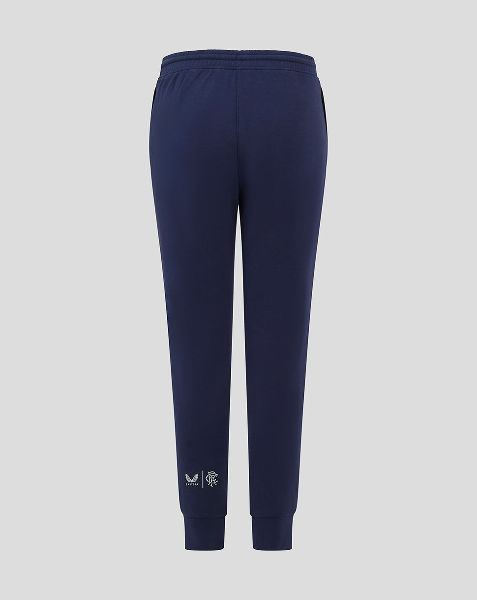 Navy Rangers FC junior travel pants with external drawcords gusset ribbed cuffs and zipped pockets with logos at right pocket and left calf