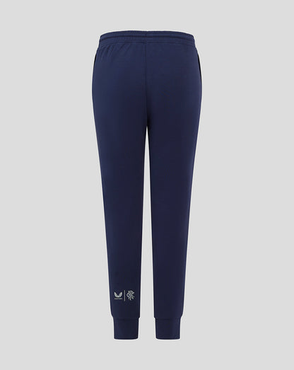 Navy Rangers FC junior travel pants with external drawcords gusset ribbed cuffs and zipped pockets with logos at right pocket and left calf