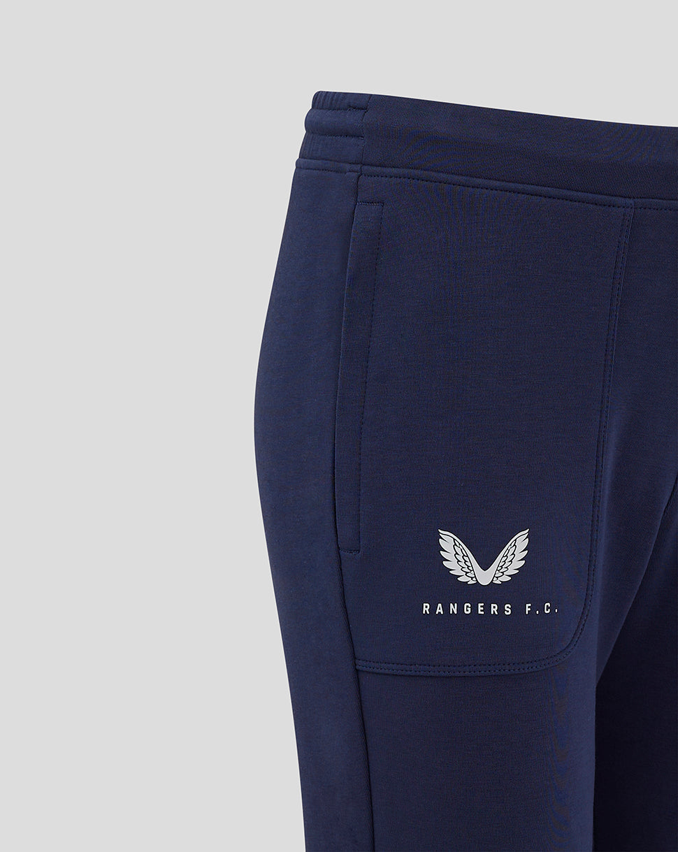 Close-up of navy Rangers FC junior travel pants with white logo on left calf